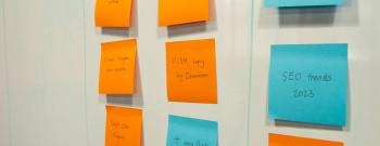 Kanban board with sticky notes moving through columns